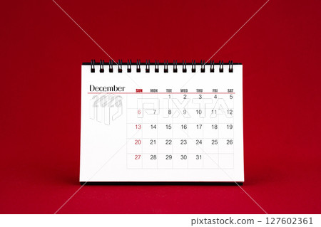 December 2026 Blank desk calendar on red color background. 127602361