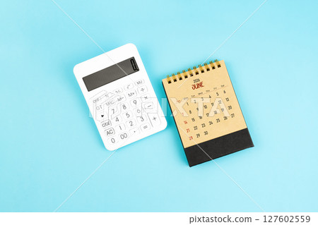 June 2026 brown caculator and white calculator on blue color background. 127602559