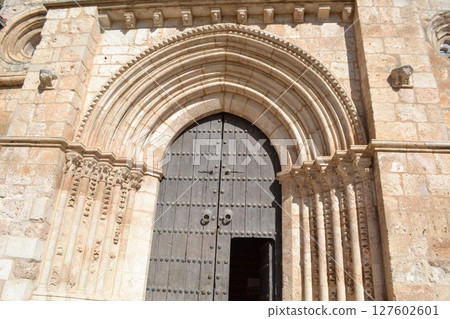 Historic romanesque church doorway in brihuega spain on a sunny day. Iglesia de San Felipe. Church Saint Felipe in Brihuega, Guadalajara, Spain 127602601