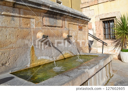 Historic stone fountain with flowing water in Brihuega, Spain Historic stone fountain with flowing water in Brihuega, Spain 127602605