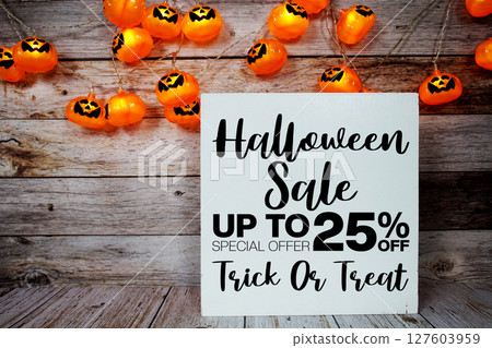 Halloween Sale 25% off text with LED pumpkin decoration on wooden background Halloween Sale 25% off text with LED pumpkin decoration on wooden background 127603959