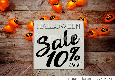 Halloween Sale 10% off text with LED pumpkin decoration on wooden background Halloween Sale 10% off text with LED pumpkin decoration on wooden background 127603964