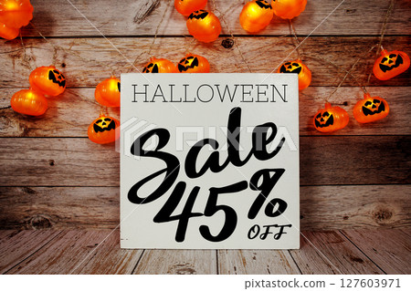 Halloween Sale 45% off text with LED pumpkin decoration on wooden background 127603971