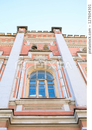 Architectural detail of historic building with ornate window, decorative elements Low angle Architectural detail of historic building with ornate window, decorative elements Low angle 127604301
