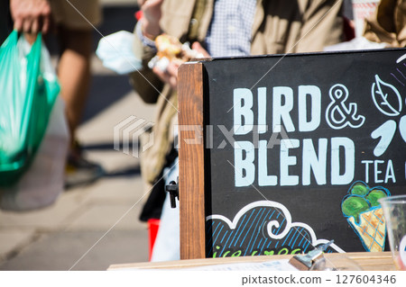An English sign in front of a cafe in bright sunlight at Portobello Market in London An English sign in front of a cafe in bright sunlight at Portobello Market in London 127604346