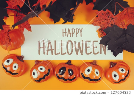 Happy Halloween text with element decorations on orange background 127604523