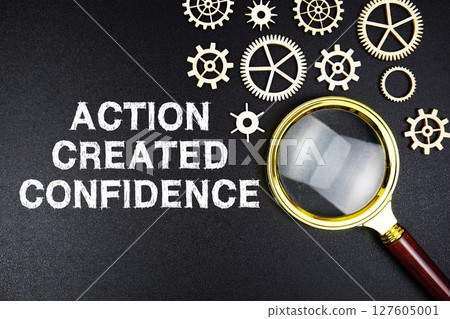 Action Created Confidence text message with magnifying glass on black background 127605001