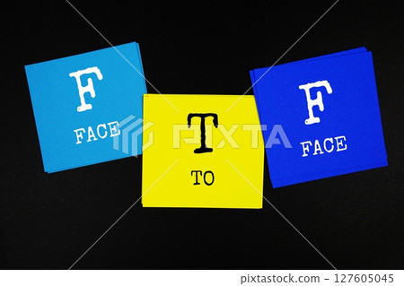 FTF - Face To Face acronym text on sticky note on black background 127605045