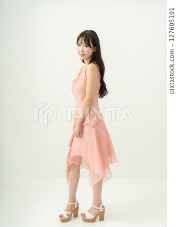 Young woman in a pink dress 127605191