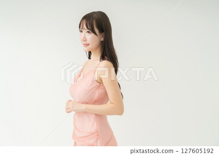 Young woman in a pink dress 127605192