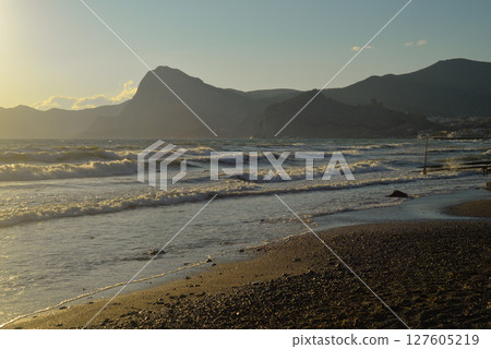 Background landscape view of Sudak Bay, the city of Sudak and its embankment in Crimea. 127605219