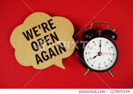 We're Open Again text on speech bubble with alarm clock on red background We're Open Again text on speech bubble with alarm clock on red background 127605244