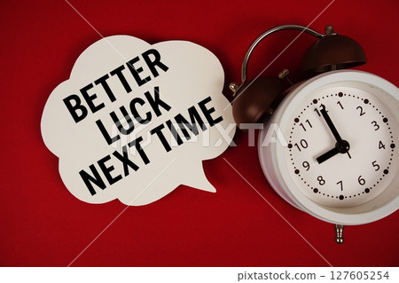 Better Luck Next Time text on speech bubble with alarm clock on red background Better Luck Next Time text on speech bubble with alarm clock on red background 127605254