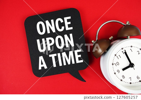 Once Upon a Time text on speech bubble with alarm clock on red background 127605257