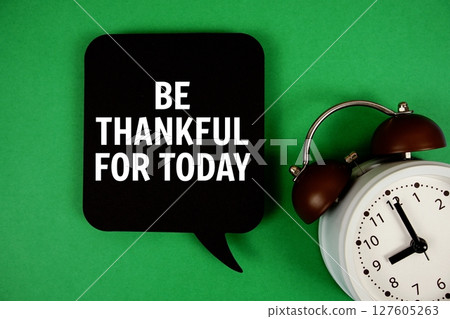 Be Thankful For Today text on speech bubble with alarm clock on green background 127605263