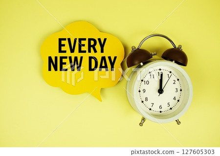 Every New Day text on speech bubble with alarm clock on green background Every New Day text on speech bubble with alarm clock on green background 127605303