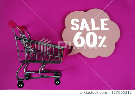 Sale 60% text with speech bubble and trolley shopping cart on pink background 127605312