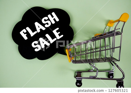 Flash Sale text with speech bubble and trolley shopping cart on green background 127605321