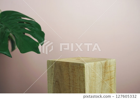Wooden podium display scene stage showcase front view with copy space and monstera leaves decoration on pink background Wooden podium display scene stage showcase front view with copy space and monstera leaves decoration on pink background 127605332