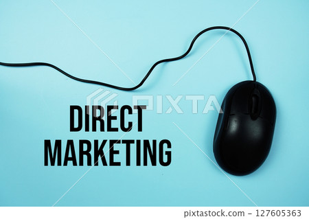 Direct Marketing text with optical mouse on blue background Direct Marketing text with optical mouse on blue background 127605363