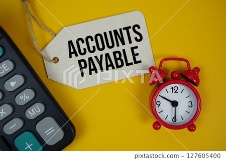 Account Payable text on price tag with calculator on yellow background Account Payable text on price tag with calculator on yellow background 127605400