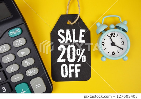 Get Extra 20% text on price tag with alarm clock and calculator on yellow background 127605405