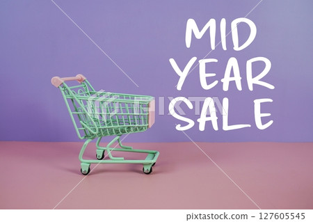 Mid Year Sale text with trolley shopping cart on purple and pink geometric background Mid Year Sale text with trolley shopping cart on purple and pink geometric background 127605545