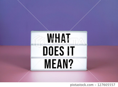 What Does It Mean? text on LED lightbox on purple and pink geometric background 127605557