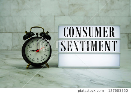 Consumer Sentiment text on LED lightbox with alarm clock on marble background 127605560