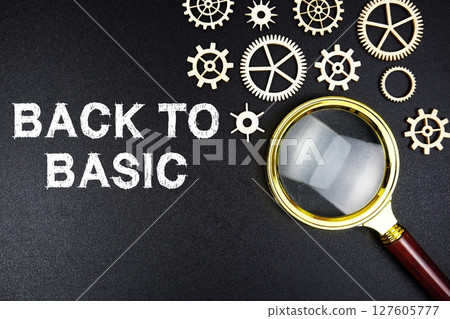 Back To Basics text message with magnifying glass on black background 127605777