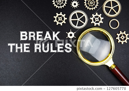 Break The Rules text message with magnifying glass on black background 127605778