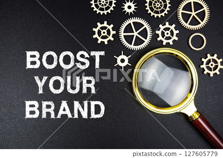 Boost Your Brand text message with magnifying glass on black background Boost Your Brand text message with magnifying glass on black background 127605779