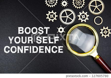 Boost Your Self Confidence text message with magnifying glass on black background 127605780