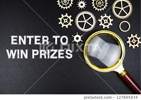 Enter To Win Prized text message with magnifying glass on black background Enter To Win Prized text message with magnifying glass on black background 127605834