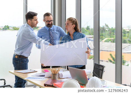 Construction engineer and architect check plan working with the blueprint on office worker conference site. Engineers team meeting for architectural project. Construction Concept. 127606243