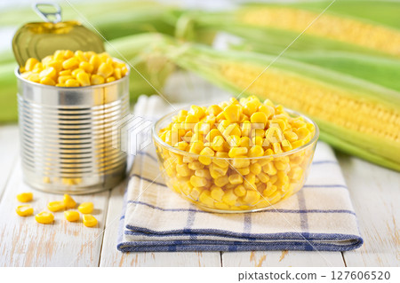 Canned food maize in a clear glass bowl on a white kitchen table, selective focus. Canned food maize in a clear glass bowl on a white kitchen table, selective focus. 127606520