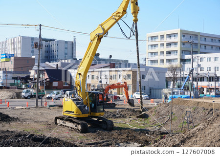 Earth auger during ground improvement work at a construction site 127607008