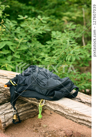 Backpack on bench Backpack on bench 127607039