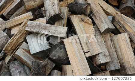A pile of aged oak firewood chopped for heating in the stove 127607225