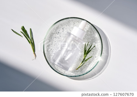 Anti-inflammatory serum and rosemary in a petri dish. 127607670