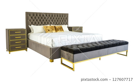 A bed with a black and gold footstool and a white pillow A bed with a black and gold footstool and a white pillow 127607717
