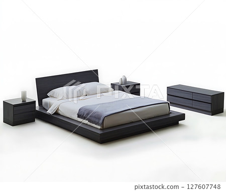 A black bed with a blue blanket and white pillows 127607748