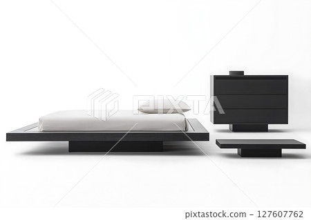 A bed with a white pillow sits next to a dresser and a nightstand A bed with a white pillow sits next to a dresser and a nightstand 127607762