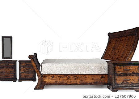 A wooden bed with a white comforter and a mirror next to it 127607900