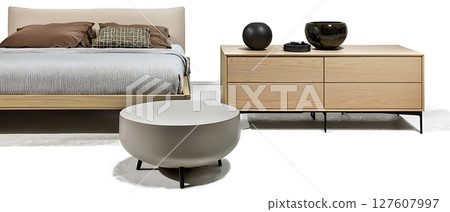 A bed with a white comforter and pillows, a white ottoman, and a white dresser A bed with a white comforter and pillows, a white ottoman, and a white dresser 127607997