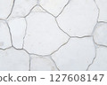 The image is of a white stone wall with a rough, jagged texture 127608147