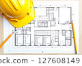 A drawing of a building with a yellow hard hat on top of it 127608149