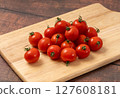 Mini tomatoes on cutting board 127608181
