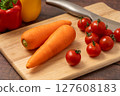 Carrots and cherry tomatoes on a cutting board 127608183