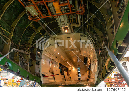 Open cargo cabin of transport freight airplane in aircraft hangar 127608422